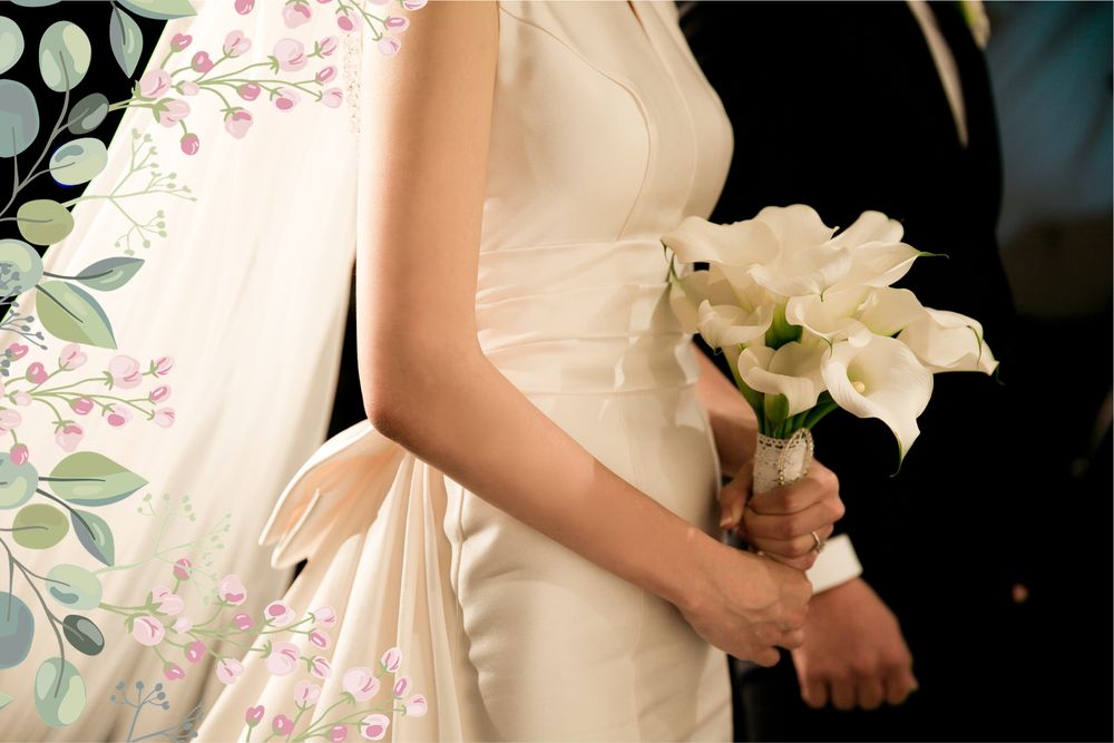 A bride holding calla lilies beside her partner